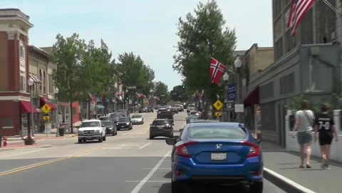 Smal lTown Main St .Flags Moderate Traffic Stock Footage 201110563