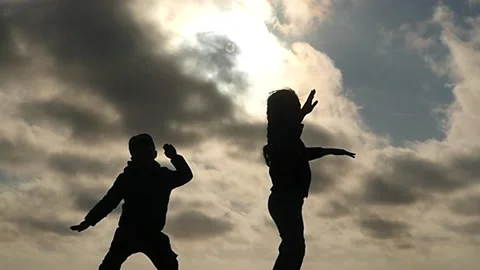 Small 5-6 years old boy and girl dancing and having fun silhouettes slomo Stock Footage 197425095