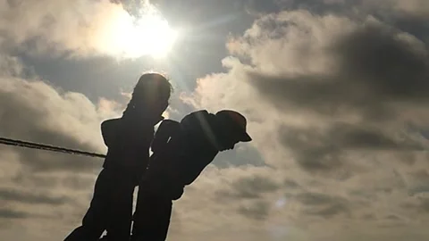Small 5-6 years old boy and girl pulling rope silhouettes slow motion Stock Footage 197425428