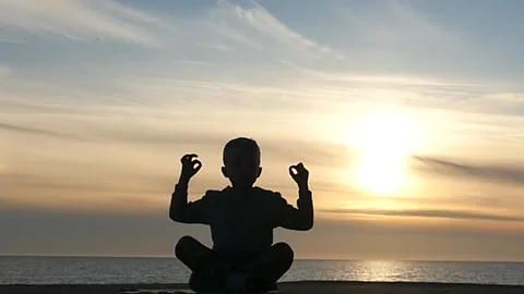 Small 5 years old boy meditation panoramic silhouette slow motion Stock Footage 197565306
