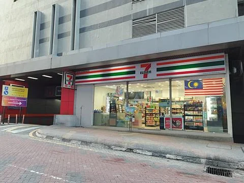 Small 7-Eleven store on the side of the building Stock Photos