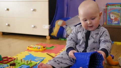 Small 9 month years old child taking on an orthopedic mat Stock Footage 127117033