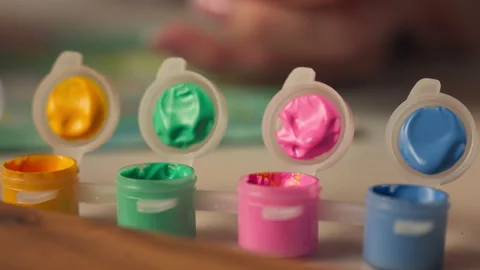 Small Acrylic Paint Pots With Lids Open And Paintbrushes Dipping. close-up shot Stock Footage 331173088