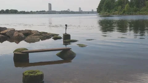 Small action camera attached to big wet stone films Daugava Stock Footage 146718351