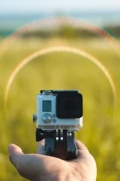 Small action camera on nature background, advertising template, Stock Photos