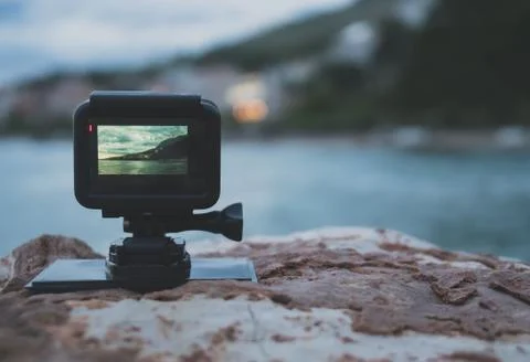 Small action camera shooting time-lapse on sunset. Stock Photos