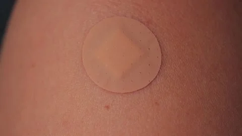 Small adhesive bandage placed on the shoulder after vaccination. Stock Footage 336680958