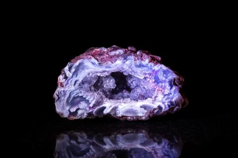 Small agate druse in front of black 스톡 사진