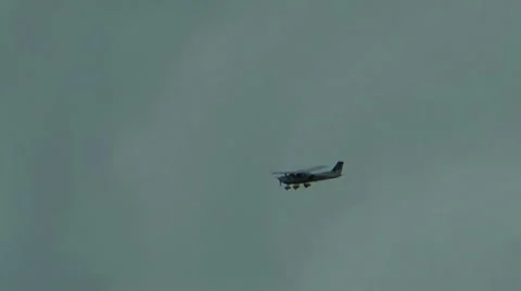Small aircraft in flight making a tight turn against grey blue sky Stock-Footage 12412148