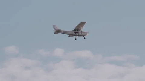 Small aircraft flying in the cloudy sky Stock Footage 295650348