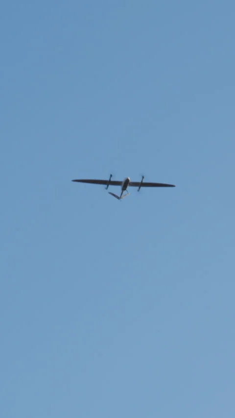 Small aircraft flying high in a clear blue sky, showcasing its sleek design and Video stock 314269599
