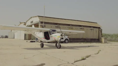 Small aircraft in front of hangar Stock Footage 275402613