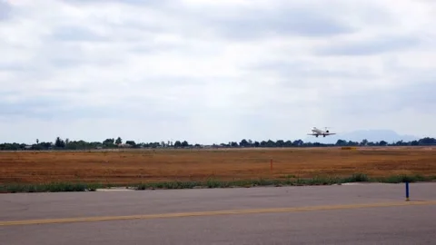 Small aircraft landing under a cloudy sky Video stock 137089912