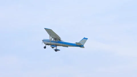 Small aircraft model Cessna flying over airport. Small private single engin.. Stock Footage 247742289