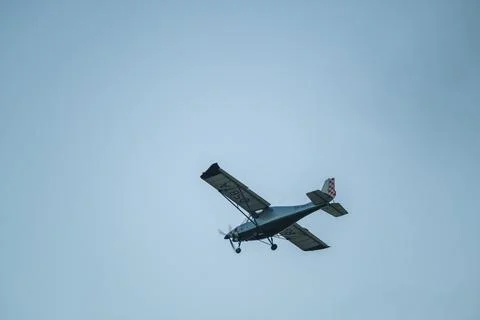 Small airplane against cloudless evening sky Stock Photos