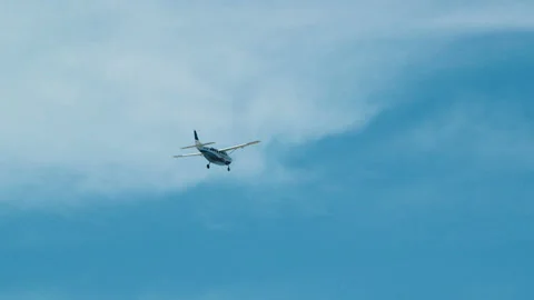 Small Airplane Flying off in the blue sky Wide Shot Stock Footage 148528510