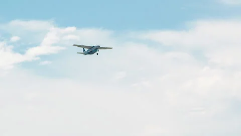 Small Airplane Flying in the blue sky wide Stock Footage 148528635