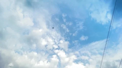 Small airplane flying high in blue sky with white fluffy clouds and power l.. Vidéo 343405801