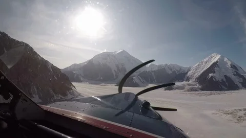 Small airplane flying next to mountains at a very close proximity in Alaska. Stock-Footage 127067488