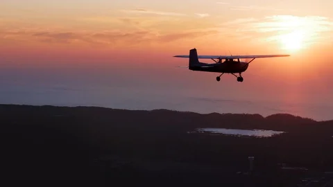 Small Airplane Flying into the Sunset Avaition Flight Beauty Lake Air to Air Stock Footage 125479503