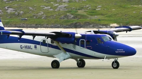 Small Airplane Moves on a Sandy Beach of Barra Airport, Scotland Stock Footage 156419134