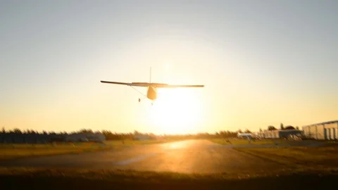 Small airplane passing and landing at the airport. Stock Footage