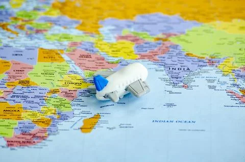Small airplane placed on a world map representing travel or global exploratio Stock Photos