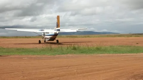 Small Airplane Prepares for Takeoff on Dirt Airstrip in Africa  (HD) Stock Footage 12401487