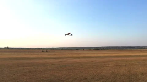 Small airplane with propeller engines flying in a clear blue sky. Aerial view Stock Footage 238462639