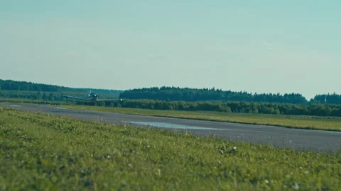Small airplane taking off along single runway in a domestic airport. Slow motion Stock Footage 202124056