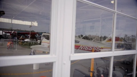 Small Airplanes Through Window in Hanger, under Repair Stock Footage 99267596