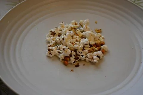 Small amount of popcorn on plate cost of living concept Photos