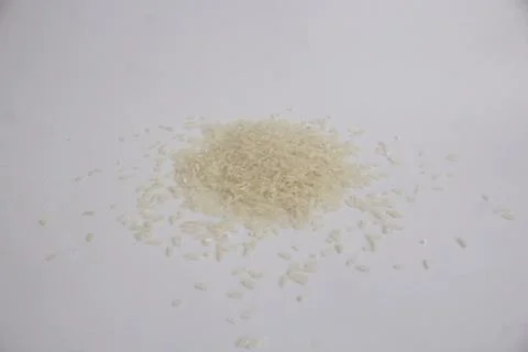 Small amount of raw white rice isolated in white background Stock Photos