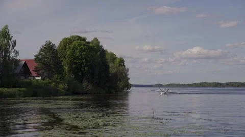 A small amphibious plane landed on a river Stock Footage 329248876