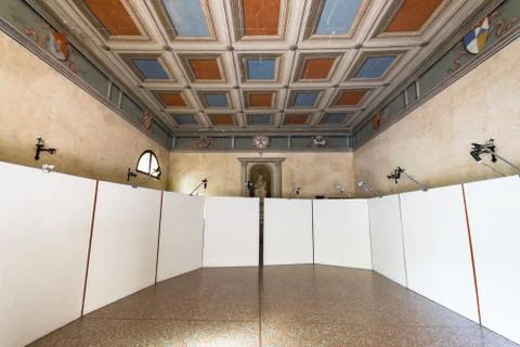 Small ancient chapel prepared to host a photographic exhibition. Stock Photos