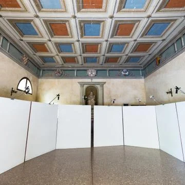Small ancient chapel prepared to host a photographic exhibition. Stock Photos