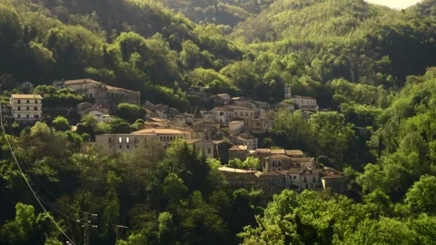 A small ancient town on the slope of forest mountains in Italy Stock Footage 272752598