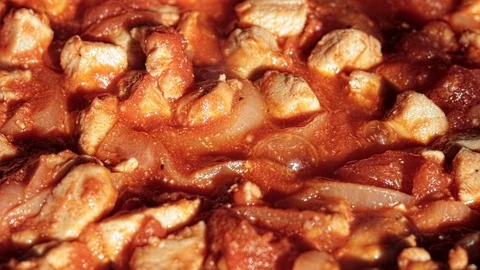 Small and appetizing pieces of meat in tomato sauce. Stock Footage 127500271