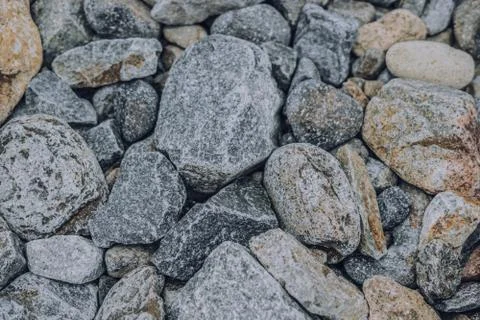 Small and big smooth round pebbles, sea dry stones, multicolour gray gravel Stock Photos