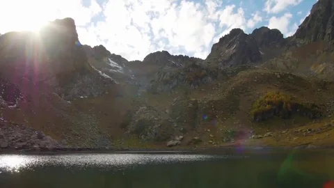 Small and clear high mountain lake with rising sun Stock Footage 69257820