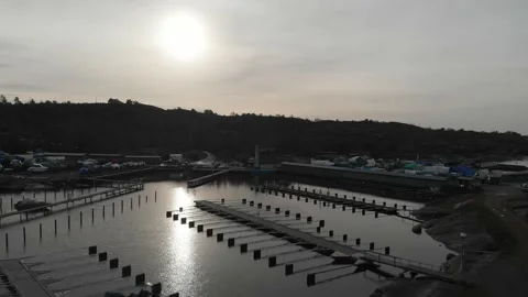 Small and Empty Harbor and Winterized Boats Ashore, Low Aerial Rising Stock Footage 145392750