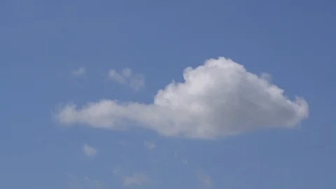 Small and fluffy cumulus cloud is moving in the clean blue sky. Video stock 107420151
