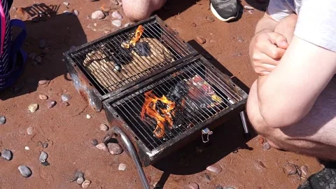 Small and old barbecue grill on sand beach with fire Video stock 264352967