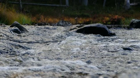 Small and shallow rocky river with rapids and waterfalls flows in the mountains. Stock Footage 140912352