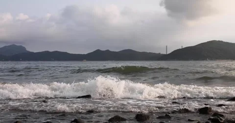 Small and soft ocean or sea wave or setup on rocky beach Stock Footage 158097905