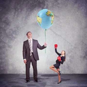 Small and Tall Executives Looking at World Balloon Fotos de archivo