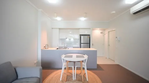 Small apartment dinging and kitchen area interior. Grey carpet, grey Stock Footage 262044989