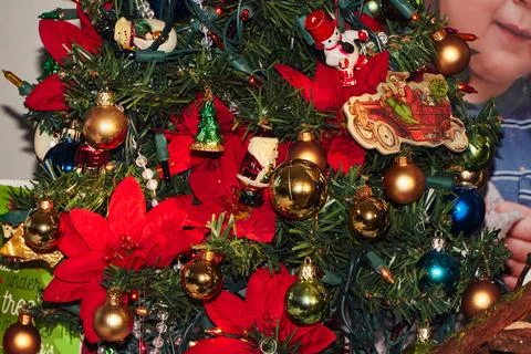 Small artificial christmas tree decorated with ornaments and lights 写真素材