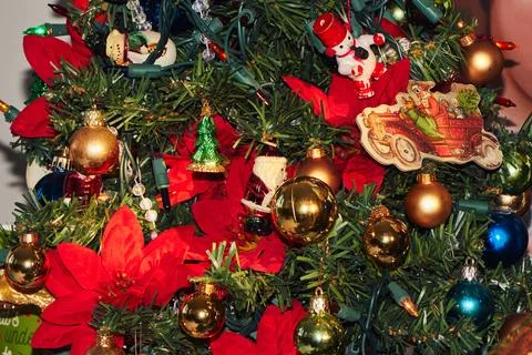 Small artificial christmas tree decorated with ornaments and lights 库存照片