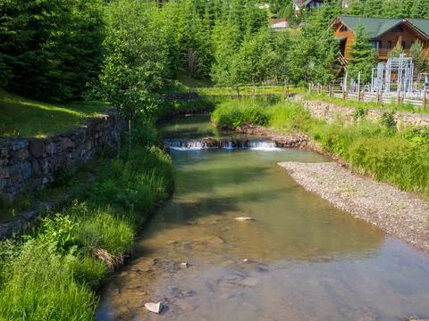 Small artificial river cascade with rocks Stock Photos